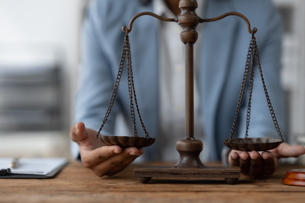 Scales Of Law Attorney Holding Scales Of Law In Front Of Her