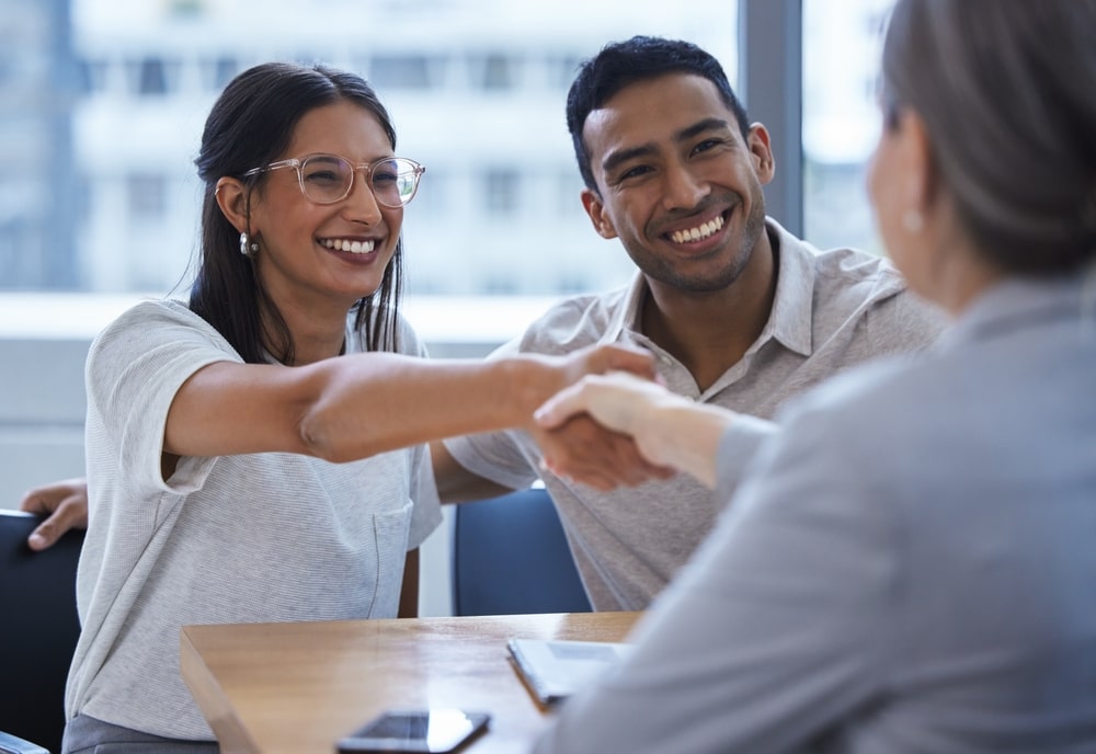 Bankruptcy Attorney Smiling Clients Shaking Hands With Their Attorney