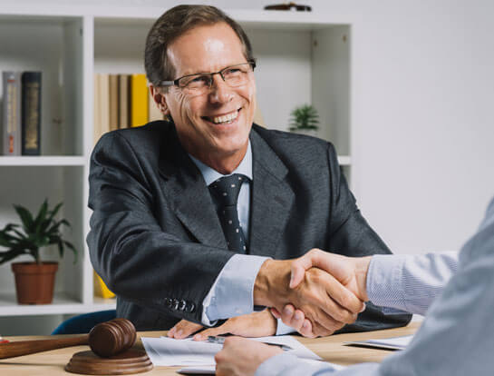 Happy attorney shaking hands with satisfied bankruptcy client